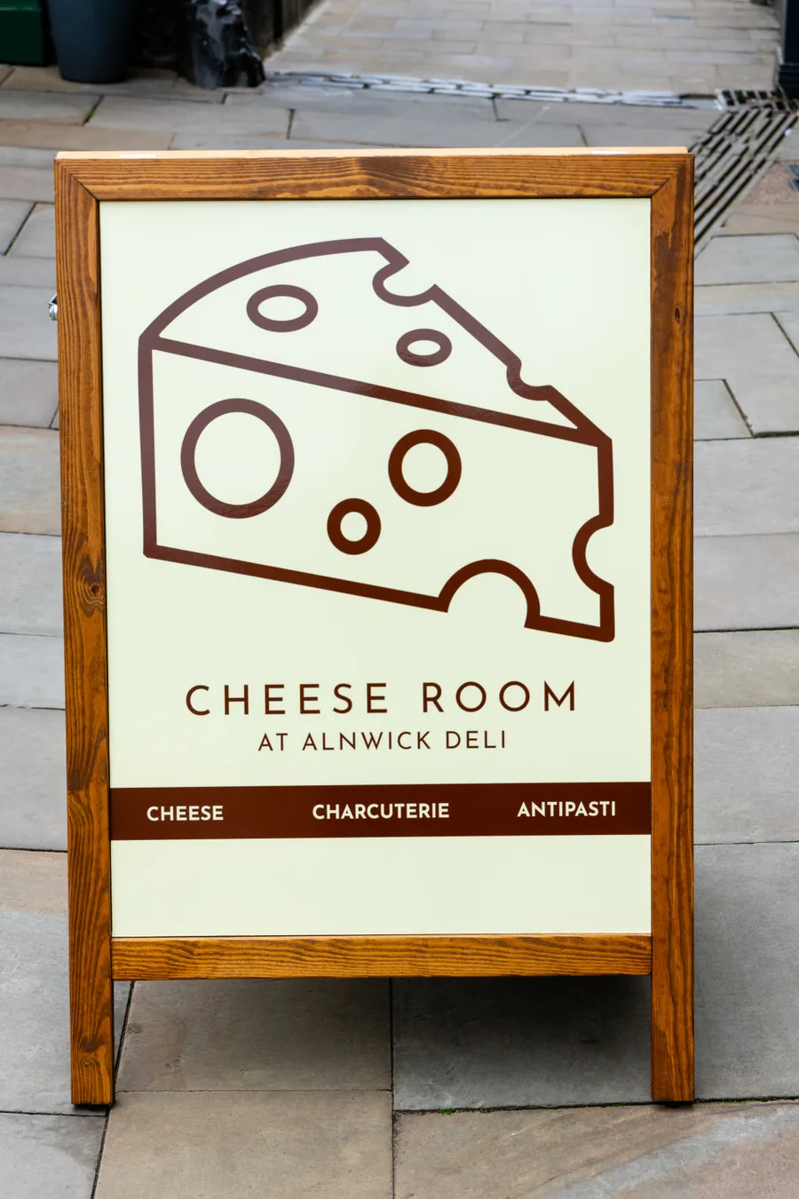 Wooden A1 A-board for Cheese Room at Alnwick Deli, cream panel with brown cheese-wedge graphic