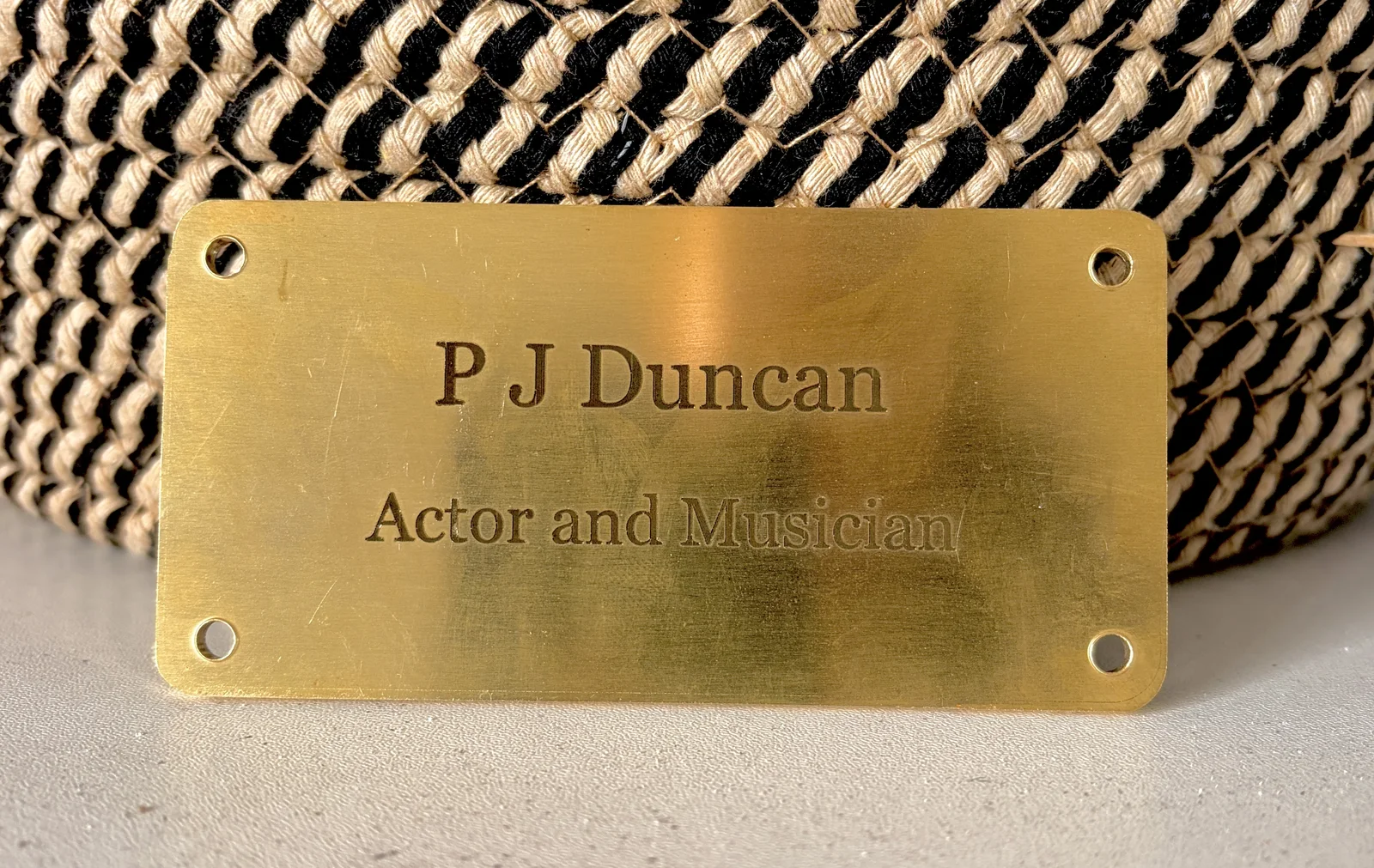 Engraved solid brass plaque reading P J Duncan, Actor and Musician, made in Alnwick