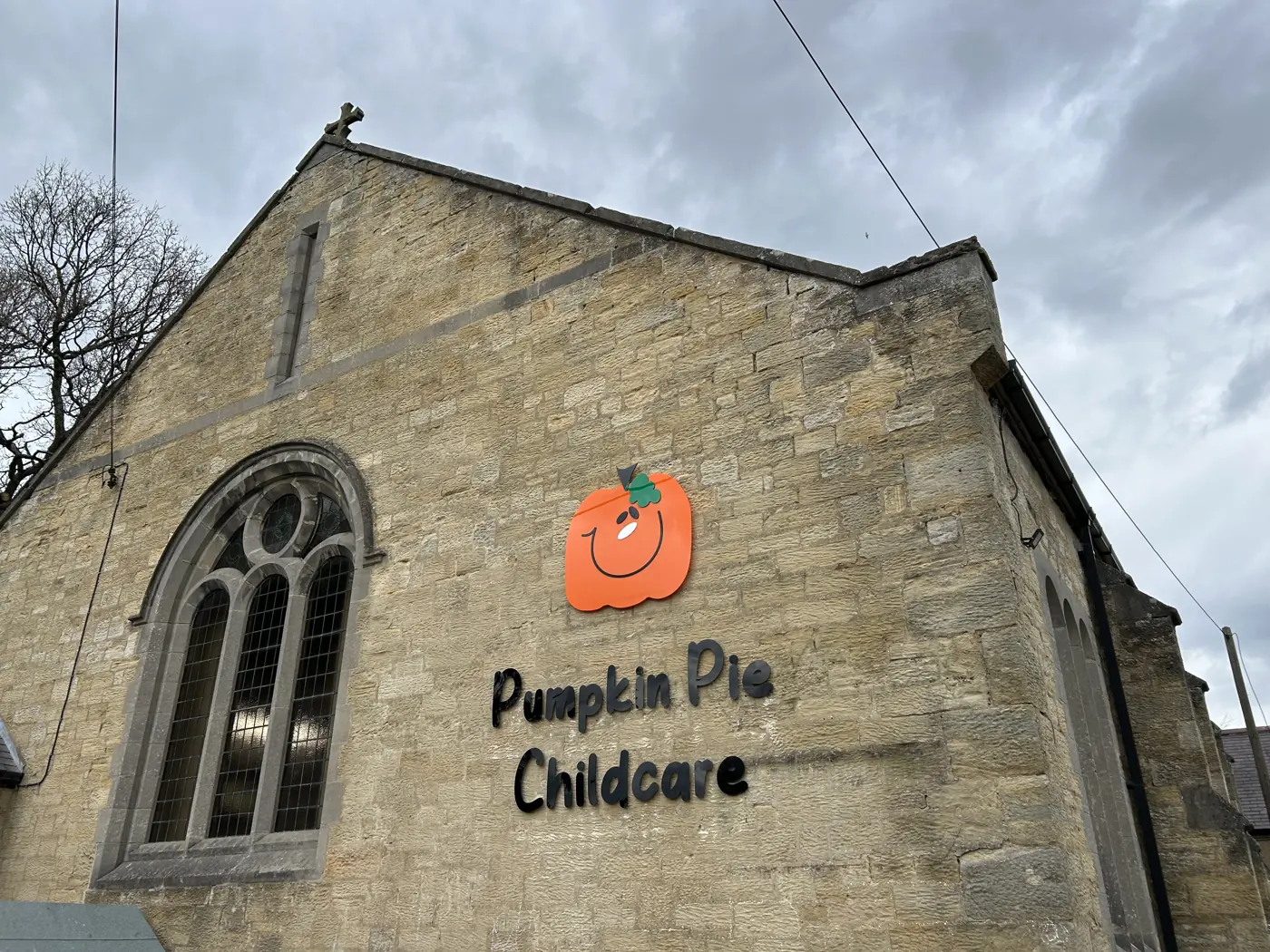 Built-up letters and pumpkin logo on a stone building for Pumpkin Pie Childcare